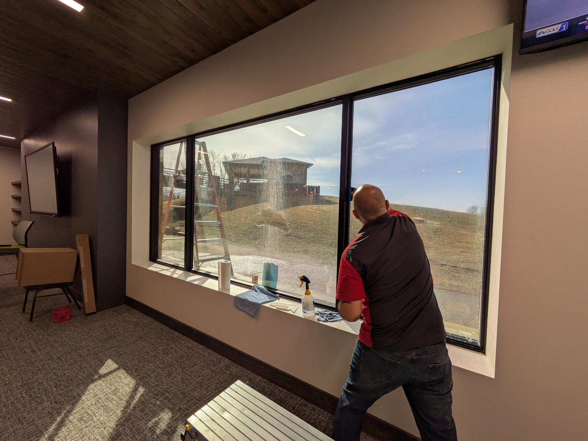 Large commercial window with window film being installed in Dakota Dunes