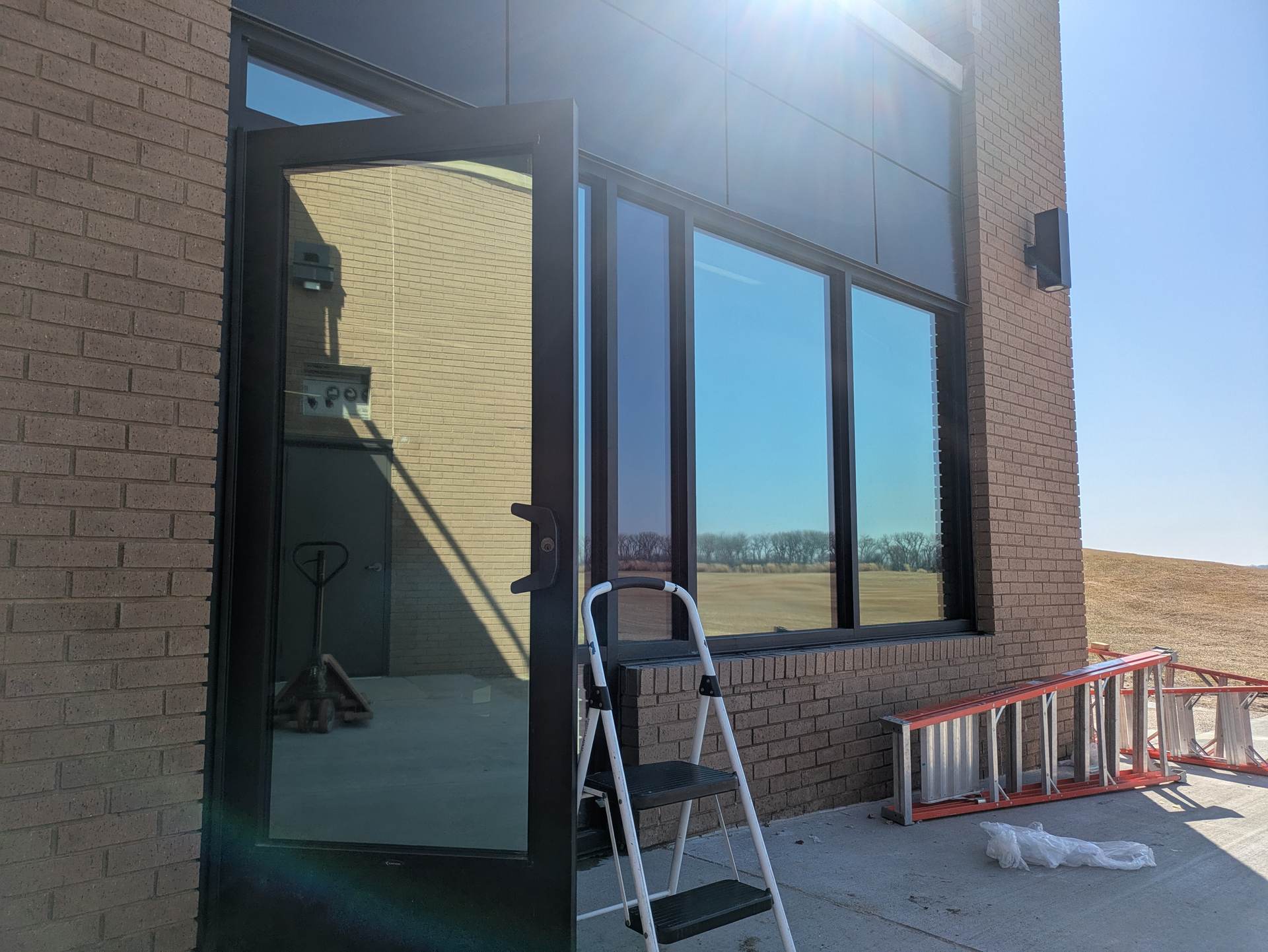 Glass entrance doors and storefront windows on a commercial building in Dakota Dunes