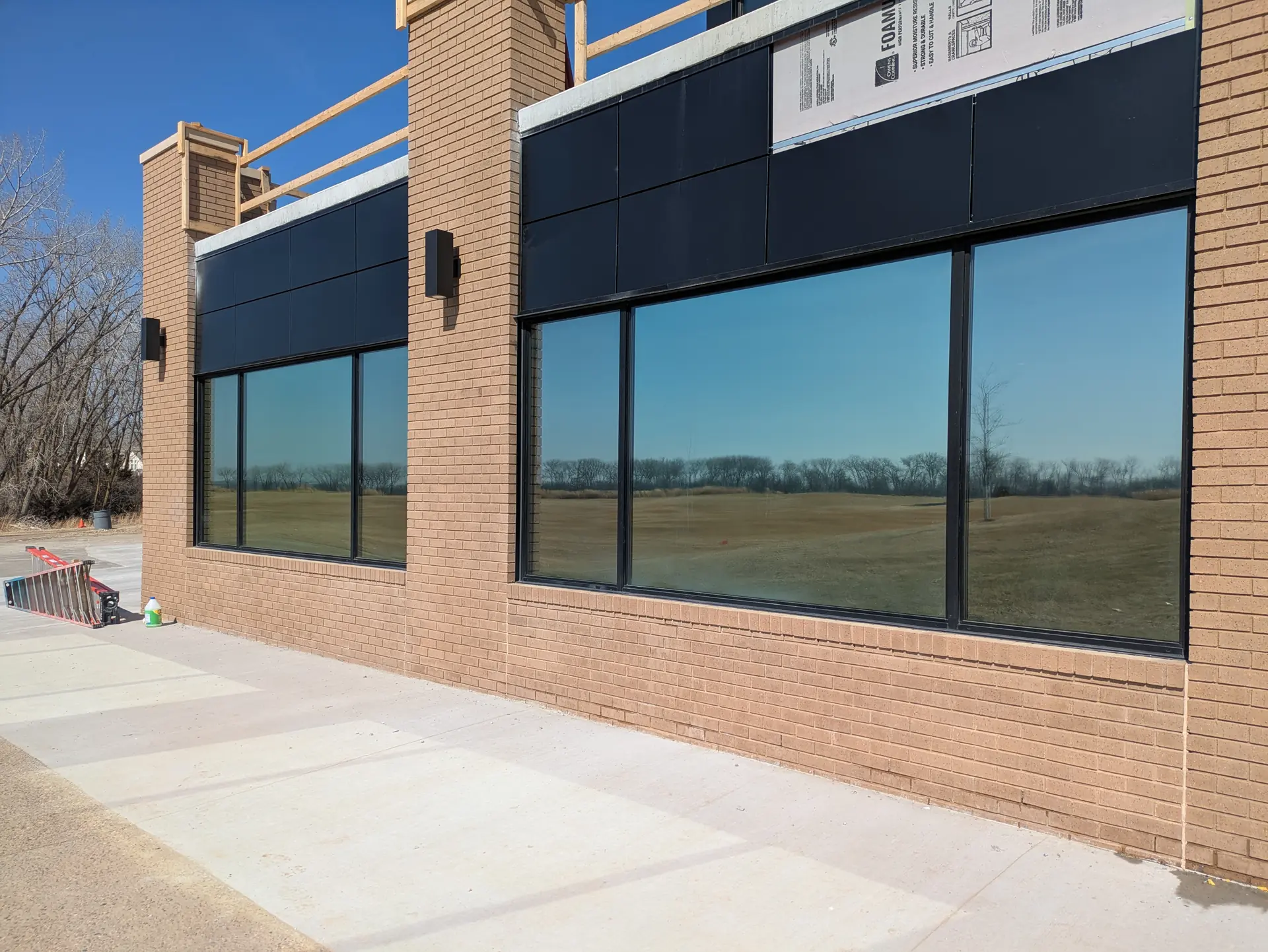 Indoor golf simulator windows with DR05 light control film in Dakota Dunes (exterior)