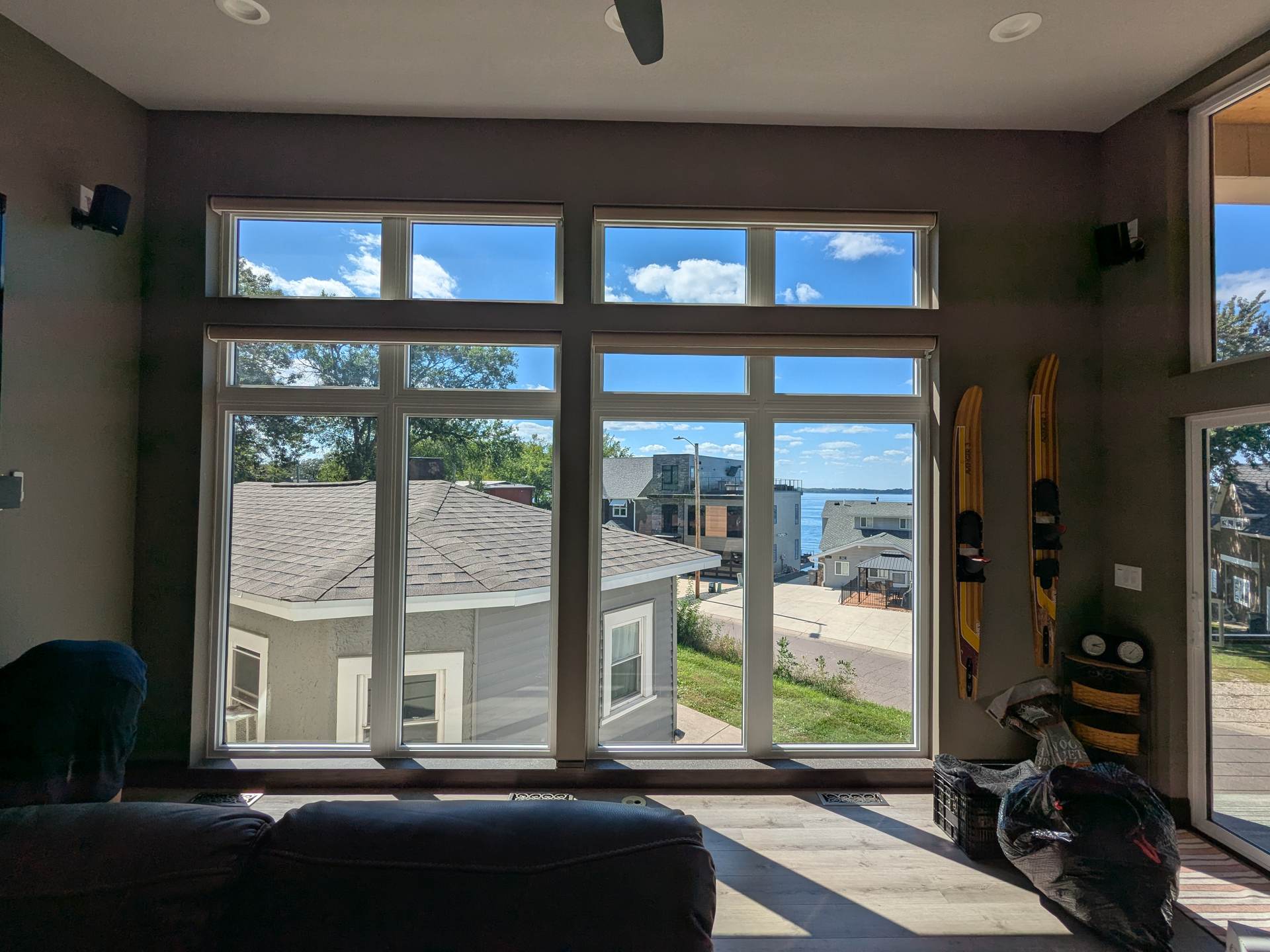 Lake home sunroom with tall windows during a solar window film install
